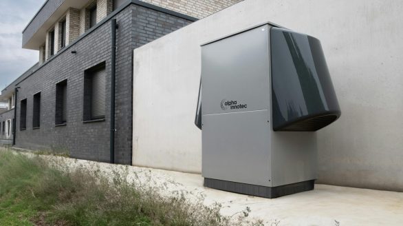 Innovative heat pump system by alpha innotec installed outside a contemporary building.